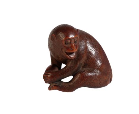 CARVED WOOD NETSUKE, BY MASAKAZU, LATE EDO PERIOD, modelled as a monkey holding a peach, 3.5cm high