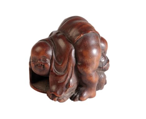 JAPANESE CARVED WOOD NETSUKE, SIGNED MASATOSHI, LATE EDO PERIOD, amusingly modelled as a child holding his nose having passed
