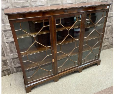 MAHOGANY REPRODUCTION THREE DOOR BOOKCASE, by Wylie &amp; Lochhead Ltd Glasgow, the three astragal glazed doors enclosing she