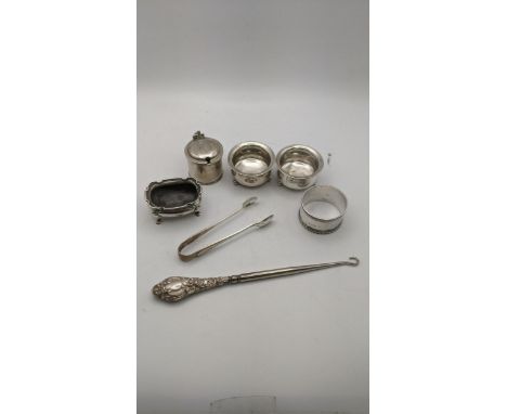 Silver to include condiment pots, sugar tongs, a napkin ring and silver handled button hook, total weight excluding glass and