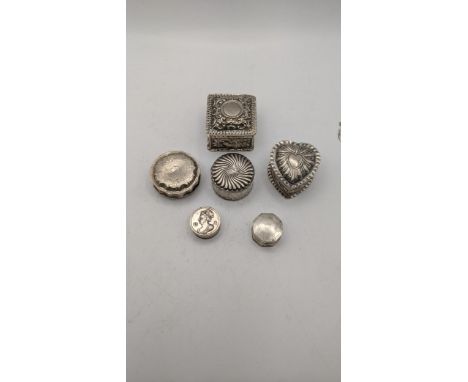 A collection of silver trinket boxes to include a heart shaped example having embossed details and others, total weight 106.2