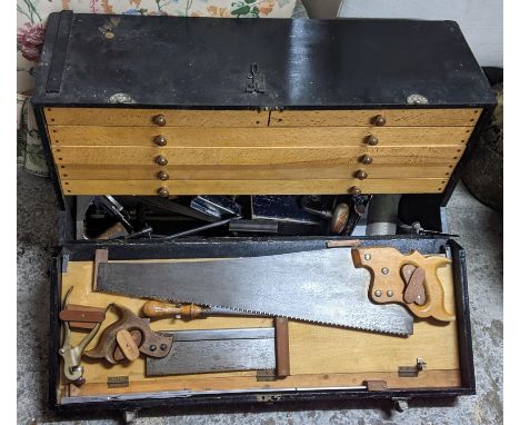 A vintage twin handled tool chest containing saws, clamps, spring callipers and other itemsLocation:If there is no condition 