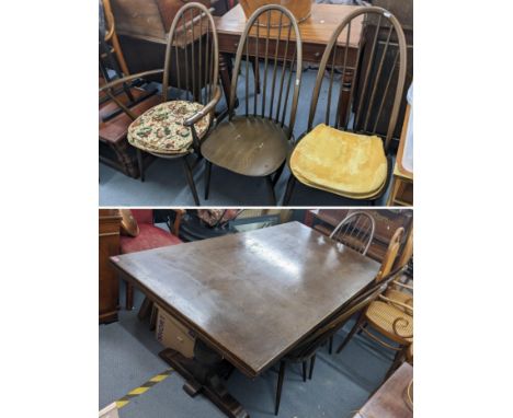 An Ercol dark oak draw leaf table with carved frieze on turned legs and a set of  six high hoop back, dark stained beech Wind