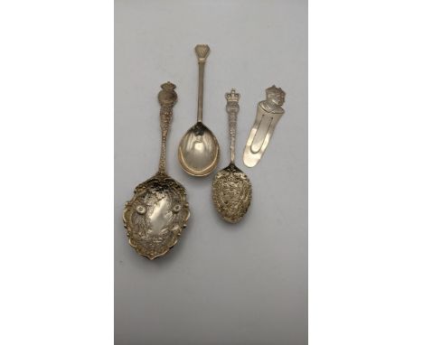 A group of silver commemorative spoons to include two floral embossed examples and one other, together with bookmark, total w