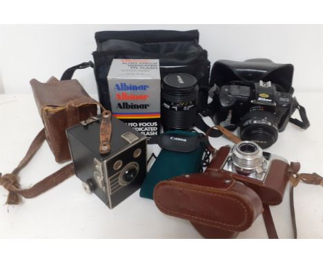 Vintage cameras to include a Nikon F-401, a Portrait brownie and a Paxette together with related accessories. Location:If the