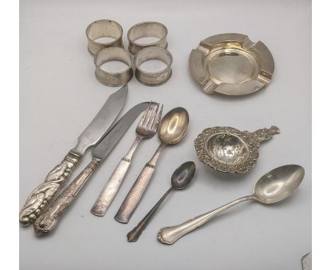 Silver to include an ashtray, white metal tea strainer stamped 830, a group of four napkin rings, a Danish sterling silver ha