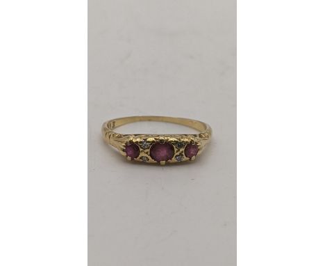 A yellow gold ring set with ruby and diamonds tested as 18ct gold purchased in Singapore 2.7gLocationIf there is no condition