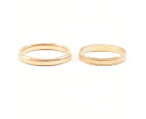 A hallmarked 9ct gold band ring. Weight 2.7g / Size N. Together with another hallmarked 9ct band ring. Weight 1.0g. All weigh