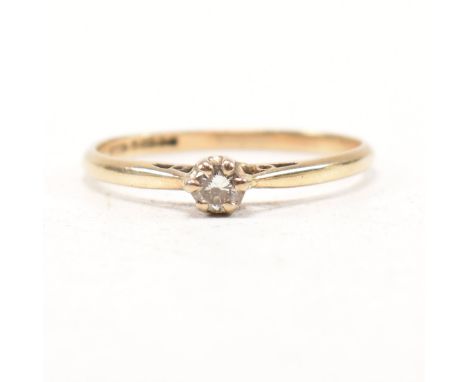 A hallmarked 9ct yellow gold and diamond solitaire ring. The single stone engagement style ring having a round cut claw set d