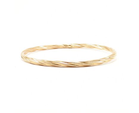 A vintage 9ct yellow gold bangle bracelet. The bangle of circular form with twisted detailing. Marked 375.&nbsp;Total weight 