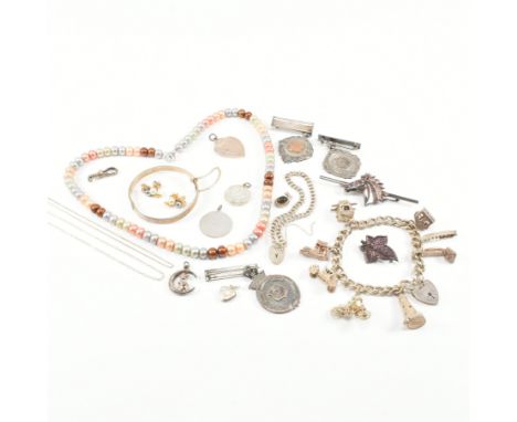 An assorted collection of antique and later silver and white metal jewellery. The lot to include a string of multi coloured c