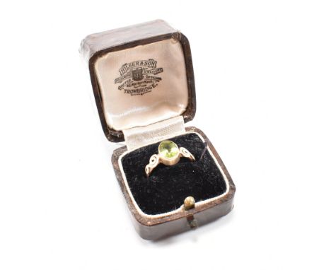 A vintage hallmarked 9ct yellow gold and peridot solitaire ring. The ring having a bezel set oval cut vibrant green stone to 