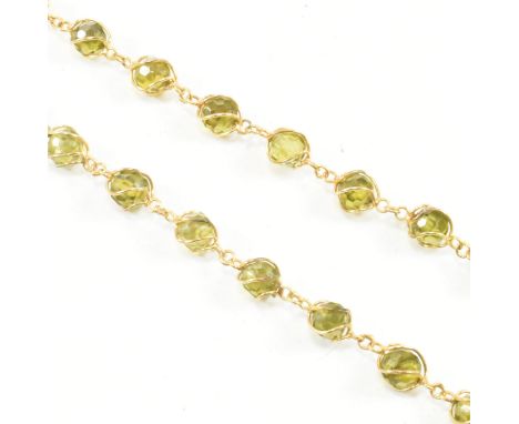 A vintage 14ct yellow gold and green stone necklace. The necklace comprised of wire wrapped green faceted beads united by a l