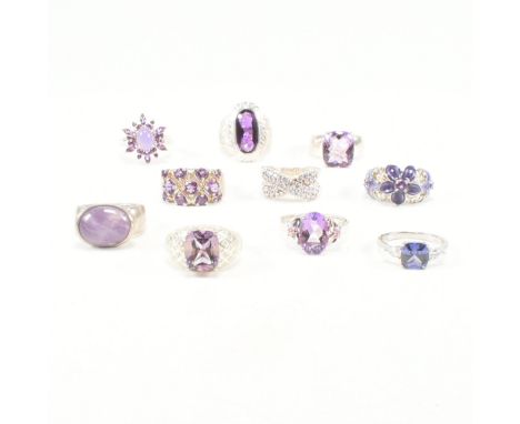 An assorted collection of 925 silver and purple stone set rings. The lot to include amethyst, cubic zirconia, enamel, floral,