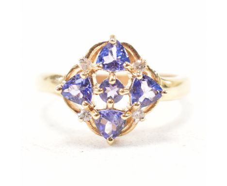 A hallmarked 9ct yellow gold, amethyst and diamond cluster ring. The ring having a central round cut purple stone surrounded 