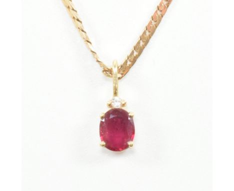 A 14ct gold, ruby and diamond pendant with gold necklace chain. The pendant having an oval cut prong set ruby with accent dia