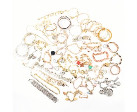 A collection of costume jewellery bracelets and bangles. The bracelets to include gold tone, silver tone, plastic, gem set, c
