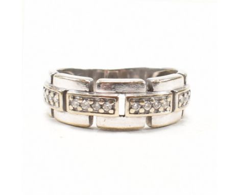 A hallmarked 9ct white gold and diamond cluster ring. The half eternity style ring of chain type form having rows of three ro