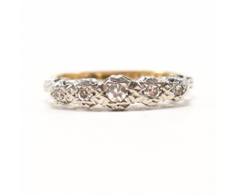 An 18ct yellow gold, platinum and diamond five stone ring. The ring having five graduating round cut illusion set diamonds wi