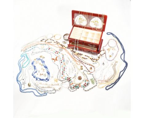 An assorted collection of vintage and later costume jewellery in wooden box. The lot to include gold and silver tone metal, e