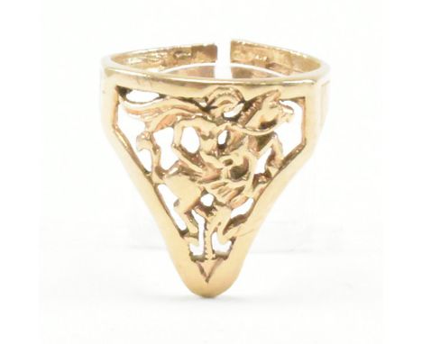 A vintage yellow metal shield ring. The ring having a pierced head depicting St. George slaying a dragon to banded shank. Unm