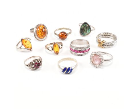 A collection of 10 silver and white metal rings. To include gem set including amber, abalone, synthetic ruby and others. Tota