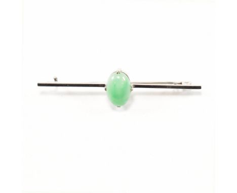 A vintage 9ct white gold and jade bar brooch pin. The brooch having a central oval cabochons of green hard stone in a double 