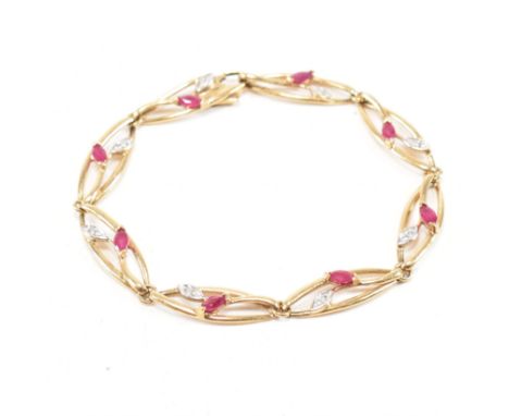 A vintage 9ct yellow gold, ruby and diamond bracelet chain. The bracelet comprised of open work navette shape links with foli