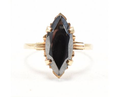 A vintage 10ct yellow gold and hematite dress ring. The ring having a marquise cut claw set hematite to a faceted head and sh