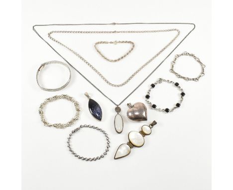 An assorted collection of silver and white metal jewellery. The lot to include necklace pendants, chains, bracelets, Kit Heat