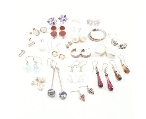 An assorted collection of silver and white metal earrings. The lot to include baroque pearls, beads, glass, aurora borealis s