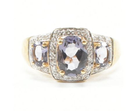 A hallmarked 9ct yellow gold amethyst and diamond triple cluster ring. The ring having three graduated oval cut amethyst each