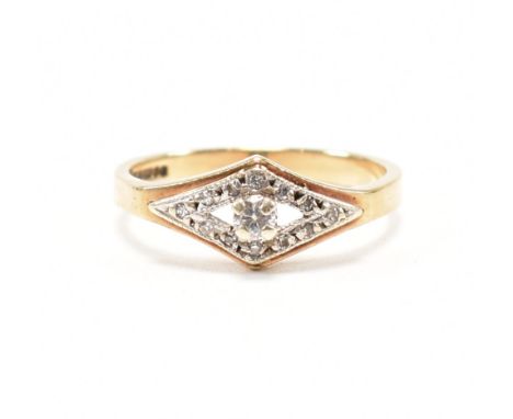 A hallmarked 9ct yellow gold and diamond ring. The ring having a round cut diamond to a navette halo of accent diamonds on a 