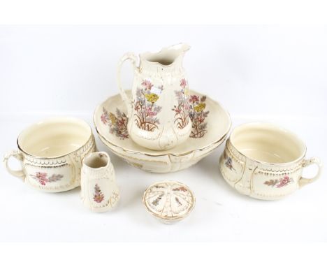 A Gordon Rose wash and toilet set. Comprising a jug and pitcher, a soap dish and two chamber pots, all decorated with floral 