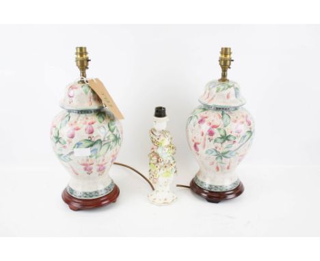 A pair of 20th century lamp bases and a Meissen style lamp base. The lamp bases decorated with floral details and mounted on 