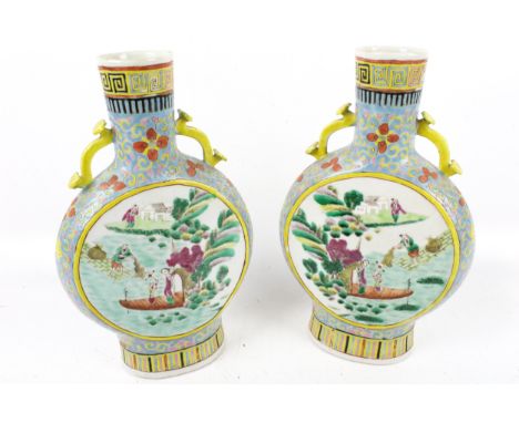 A pair of Chinese Qing period famille rose moon flasks. Apocryphal four character Kangxi mark to base. One with damage to the