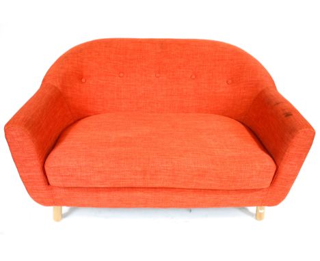 A contemporary orange two seater sofa. Raised on turned supports. L125cm x D85cm x H76cm