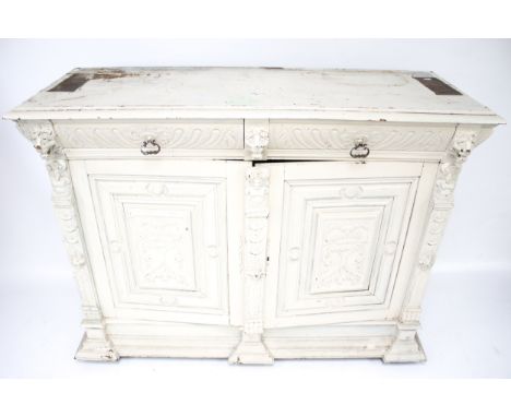 A vintage wooden cupboard base. Two short drawers over a pair of panelled cupboard doors, the frame heavily carved with figur