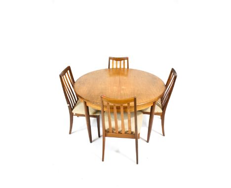 Vintage Retro : A teak circular extending dining table and four chairs. On turned tapering supports, diameter (when closed) 1