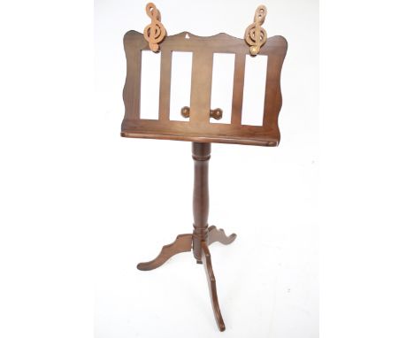A contemporary wooden adjustable music stand. Mounted on a turned column with tripod support, H105cm