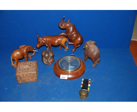 Four wooden animal carvings including Indian water Buffalo, African and Indian elephants, Rhinoceros, small Barometer, etc.