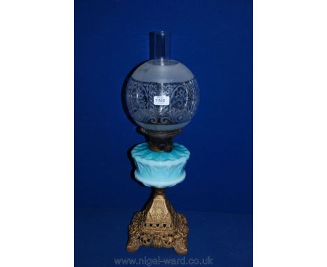 A Victorian cast iron Oil Lamp with turquoise glass reservoir and shade