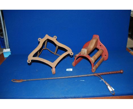 A metal Saddle rack, a wood and metal Saddle Rack and a leather handed Whip - ''The Eegee Whip''