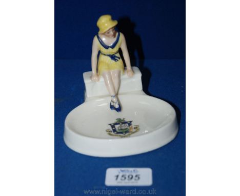 A 1930's Arcadian souvenir Ashtray from Ryde  featuring a young Lady sitting on a bench