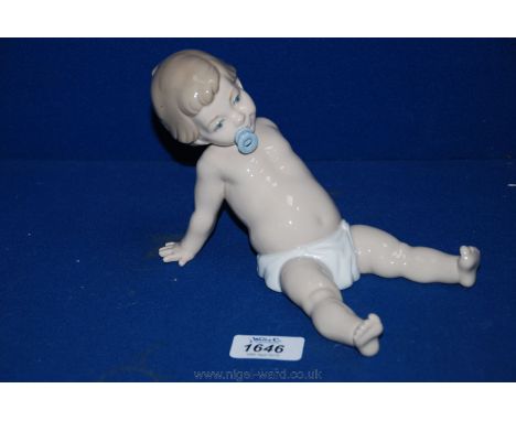 A Nao Figure of a Baby with a dummy.