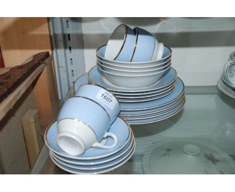 A blue and gilt Royal Doulton starter service comprising of four place settings, Cups, Saucers, Tea Plates, Cereal Bowls, Din