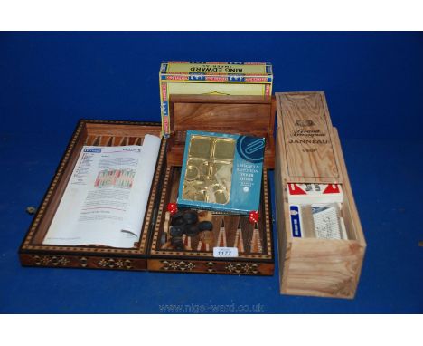 A boxed Backgammon set together with a wooden boxed dominoes and a large quantity of playing cards and a brass set of naughts