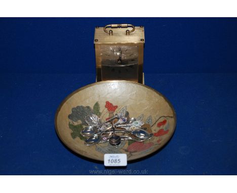 A quartz Carriage Clock, decorated enamel dish and souvenir teaspoons.