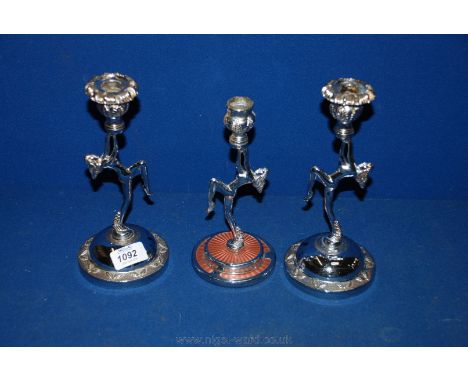 A pair of art deco chrome Candle holders and another