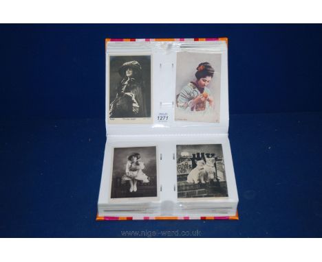 A pink/orange Album of old Postcards, art, children, actresses, photographs, greetings cards, etc.